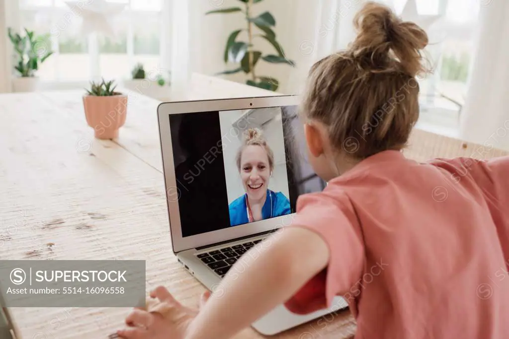 nurse having a video call with her family whilst working in a hospital