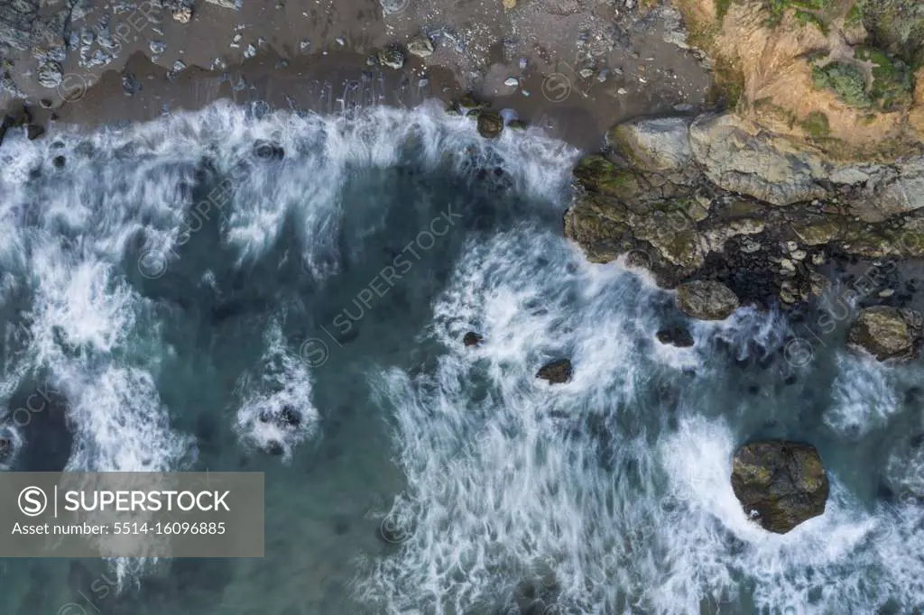 Waves Break on Rugged California Coastline Aerial