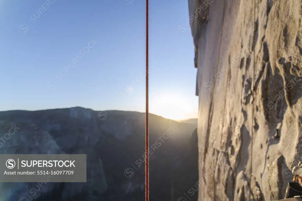 Climbing Rope hanging vertically next to El Capitan at sunset