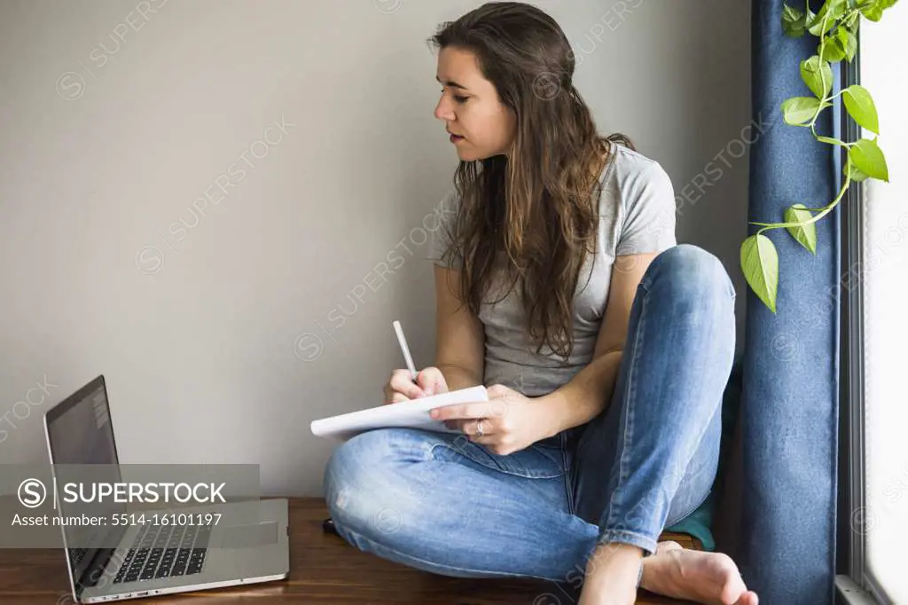 Individual Woman On her laptop working / studying at home