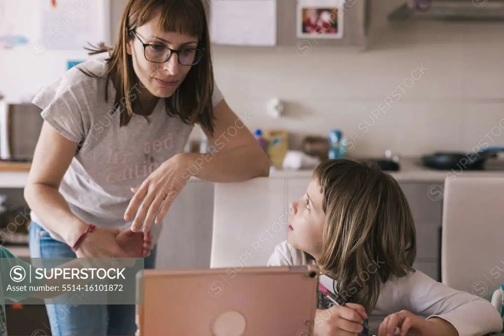 Mother and daughter reviewing homework on the tablet