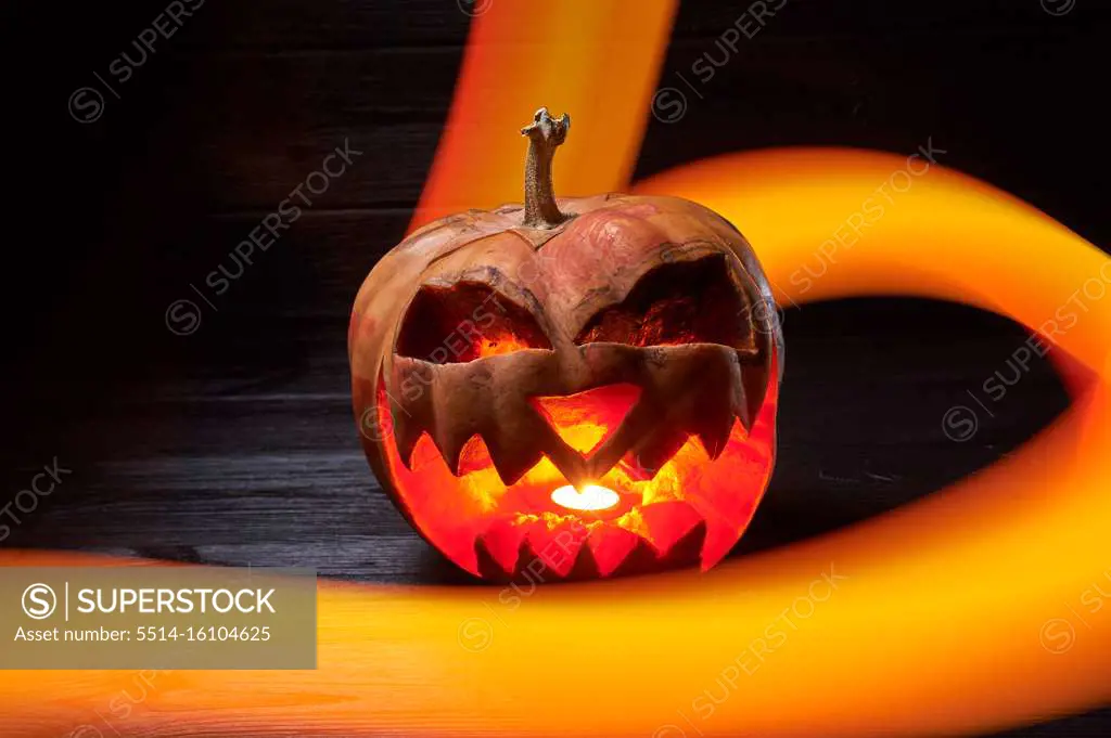 pumpkin for halloween on a black background with a long exposure
