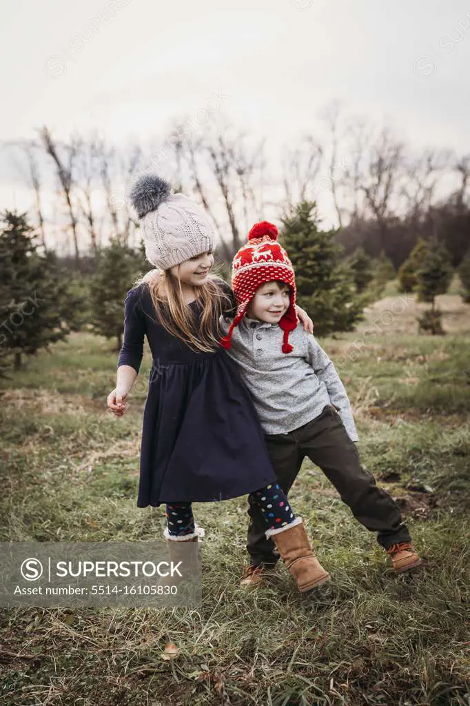 Boy and girl siblings at Christmas tree farm