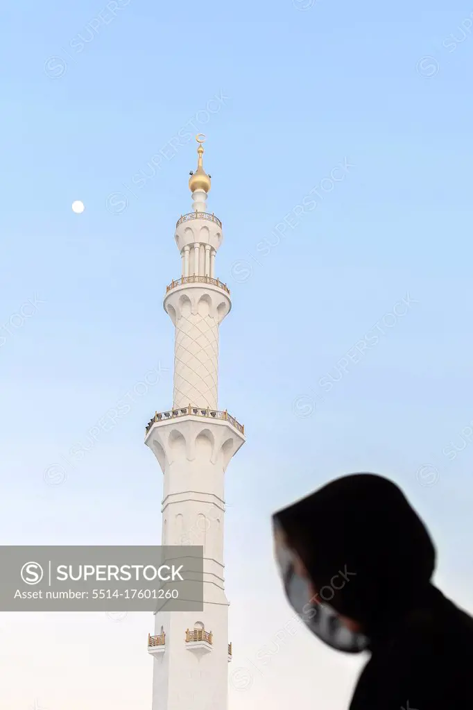 Silhouette of muslim woman, covered in black abaya in Grand mosque
