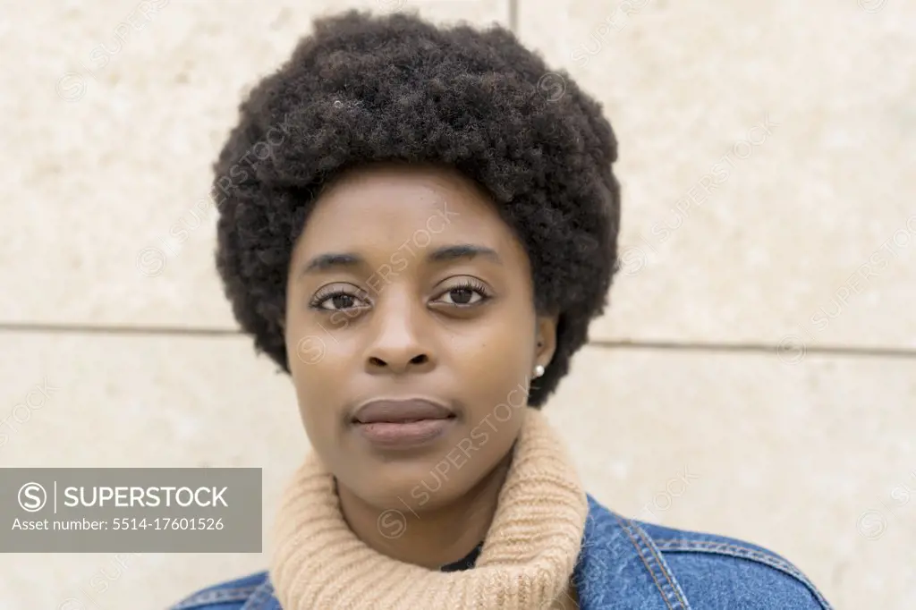 photography of elegant african woman with afro hair and blue windbreaker