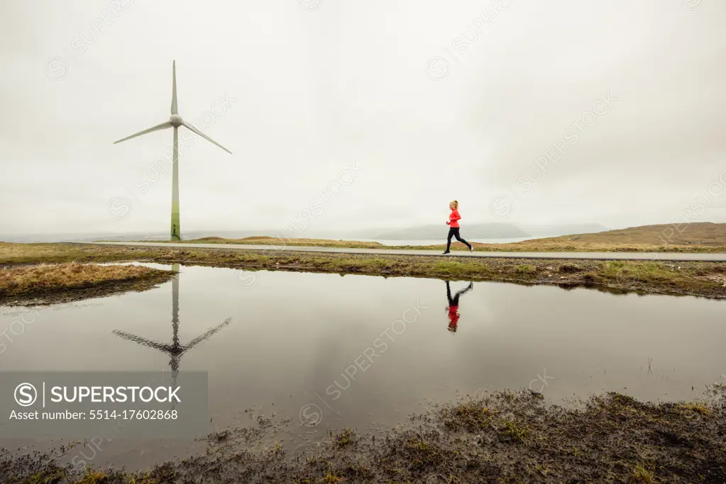 Female athlete jogging near lake