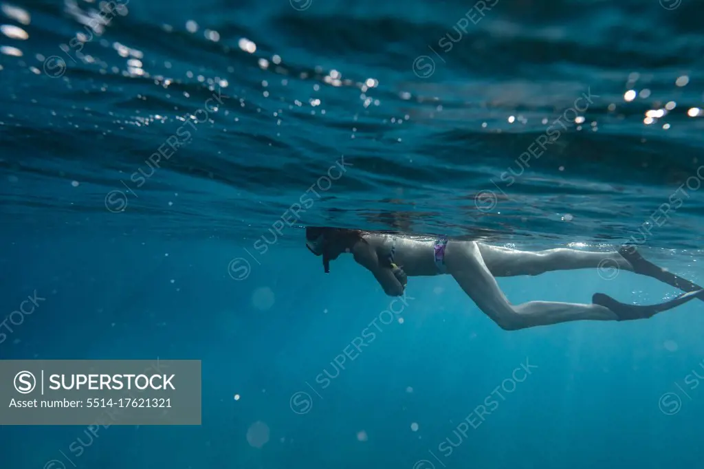 Female snorkelers on the surface of the ocean in hawaii