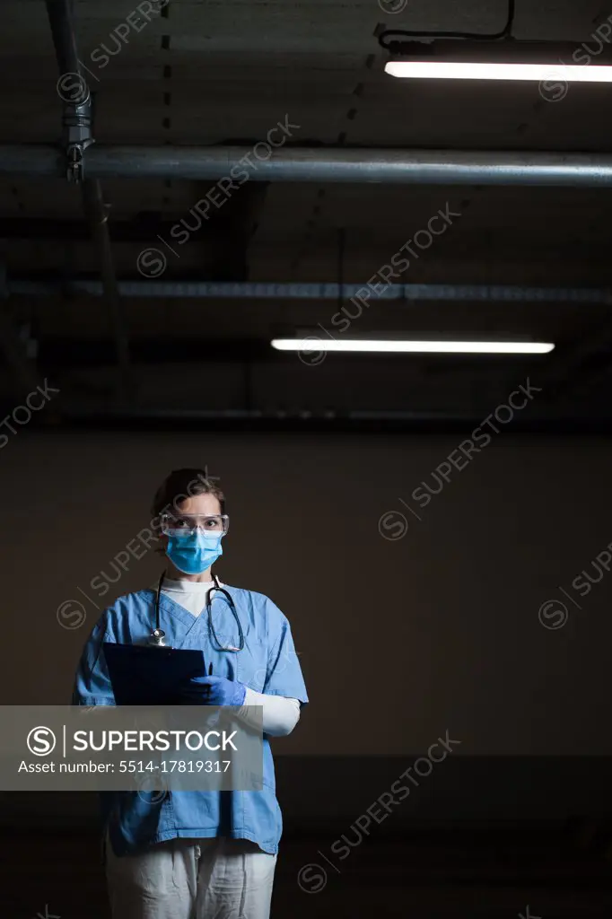 Portrait of frontline EMS key worker in dark hallway