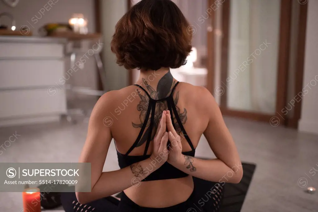 Yoga practitioner clasping hands behind back