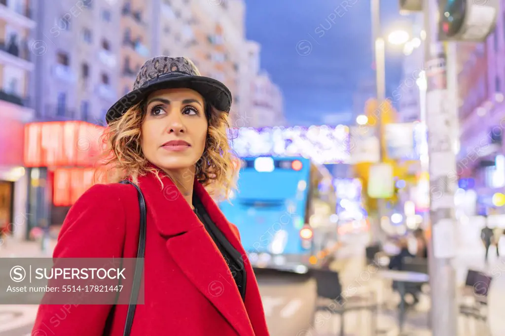 portrait of woman in red jacket in the city
