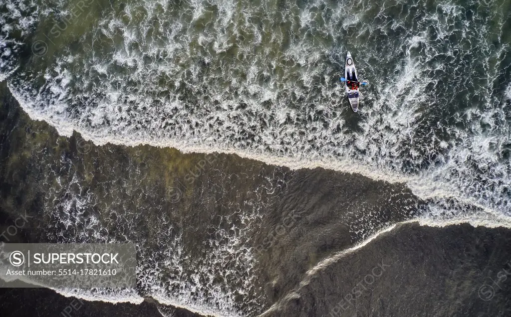 Powerful ocean waves with kayaker