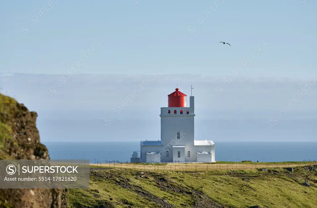 Lighthouse on seashore in morning