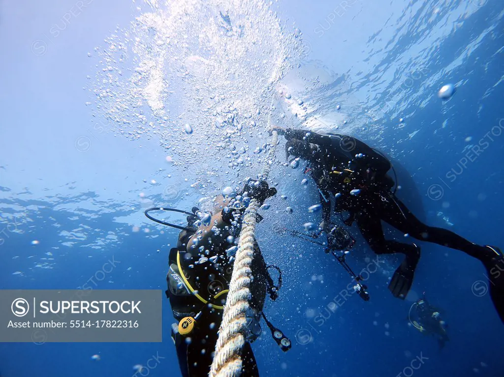 Divers hold onto the boat rope to wait for the surface. Antalya Turkey