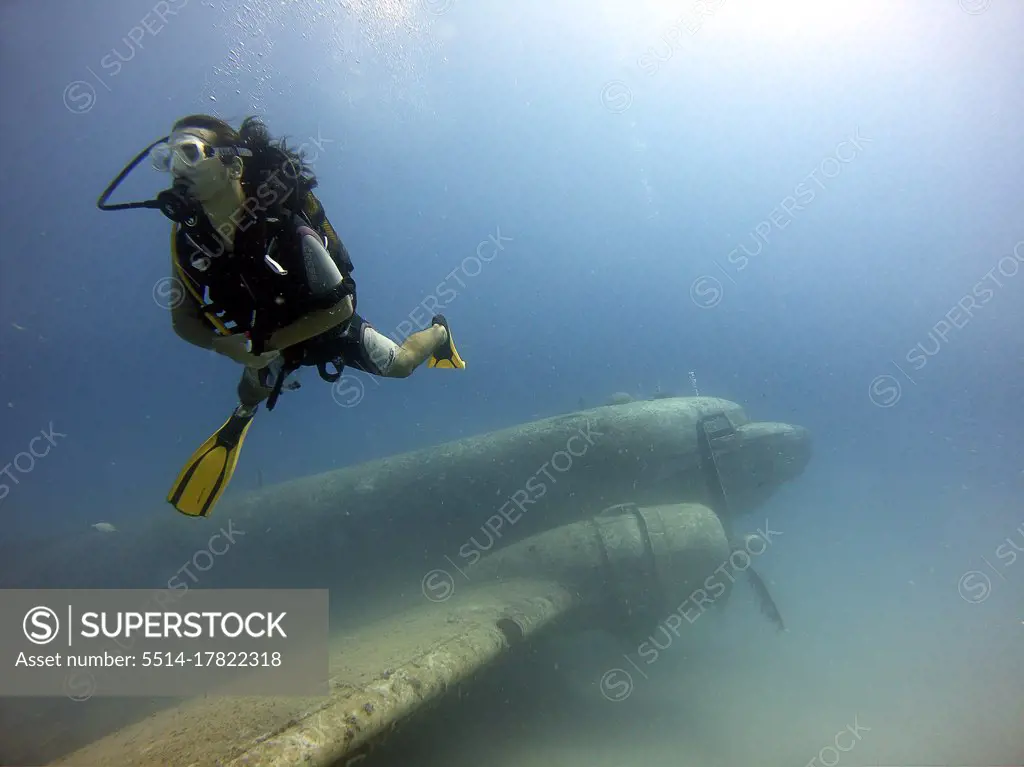 A diver hovering over a plane wreck. Antalya Turkey