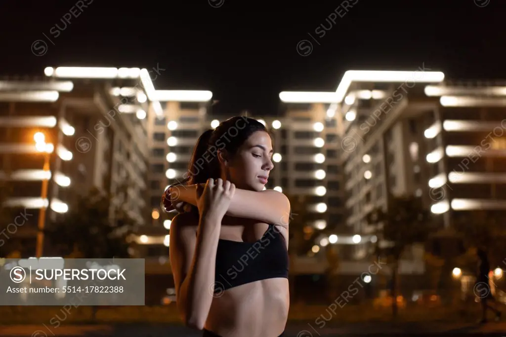 Young female training outdoors at night