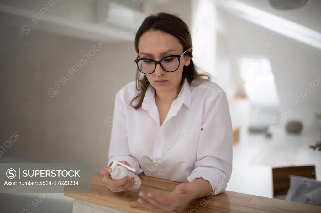 Woman washing hands with sanitizer