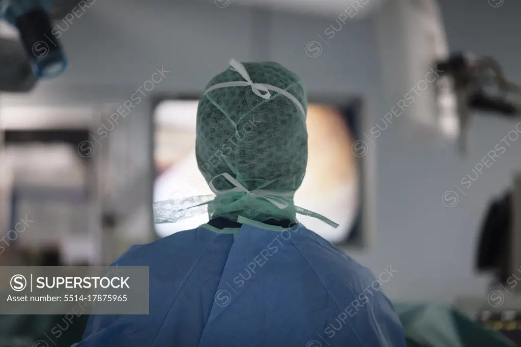 a surgeon looks at a monitor screen during surgery