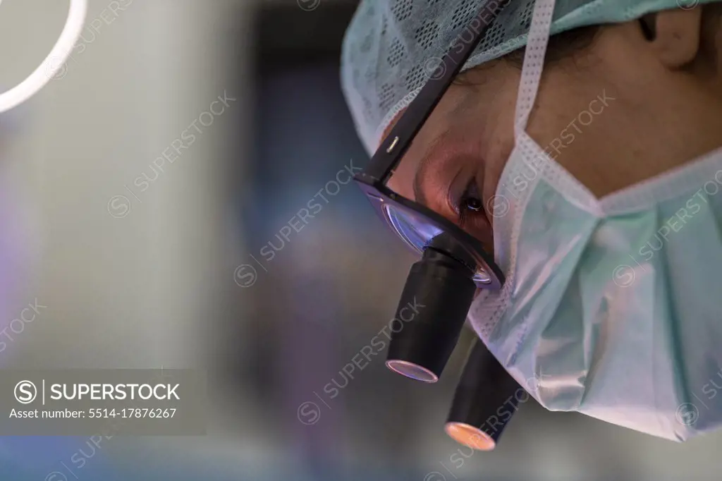 close up view of a heart surgeon wearing his magnifying glasses