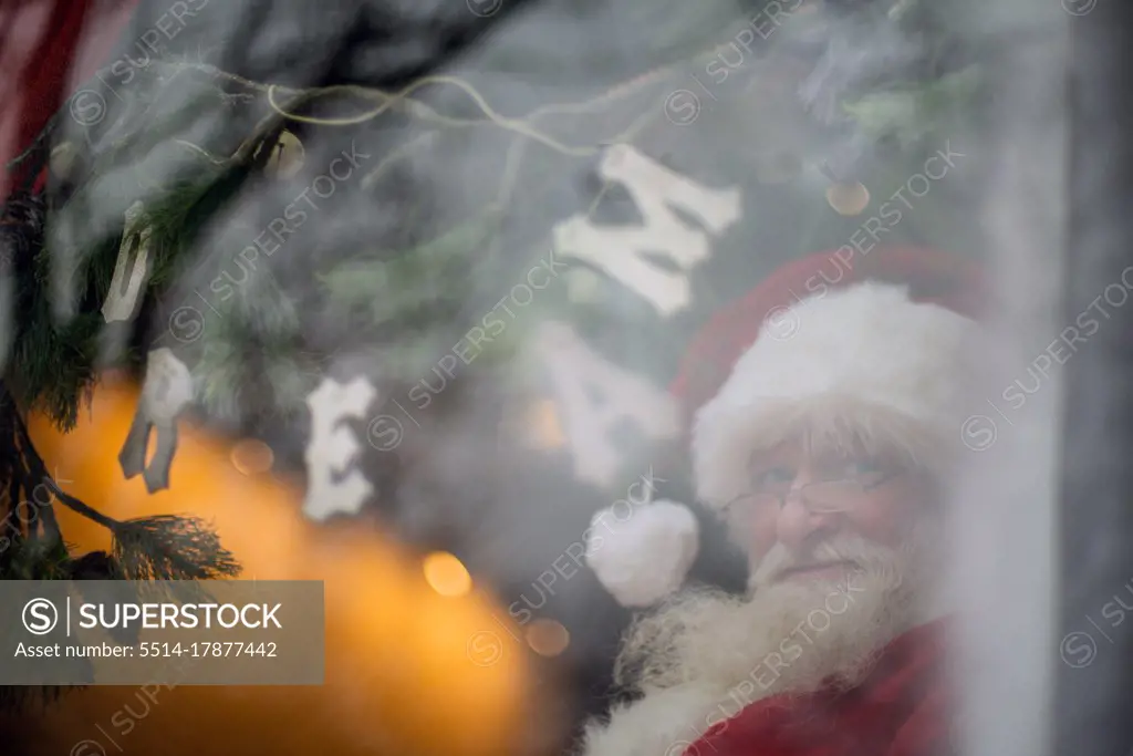 Santa sits in Window during covid