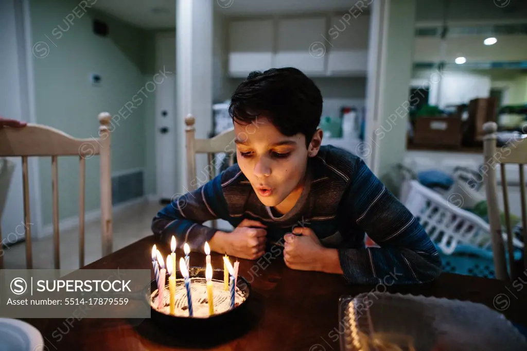 Boy Blows Out The Candles On His Cast Iron Pan Birthday Cake