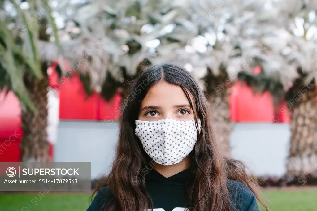 Tween Girl Wearing A Cloth Face Mask Outside Looking Yonder