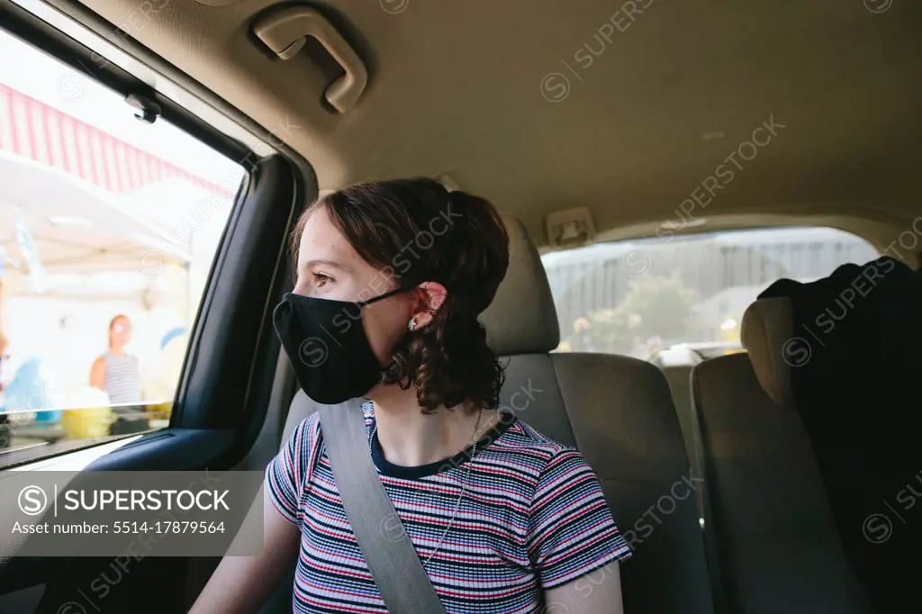 Teen Girl Sitting In the Car Driving Through Middle School Graduation
