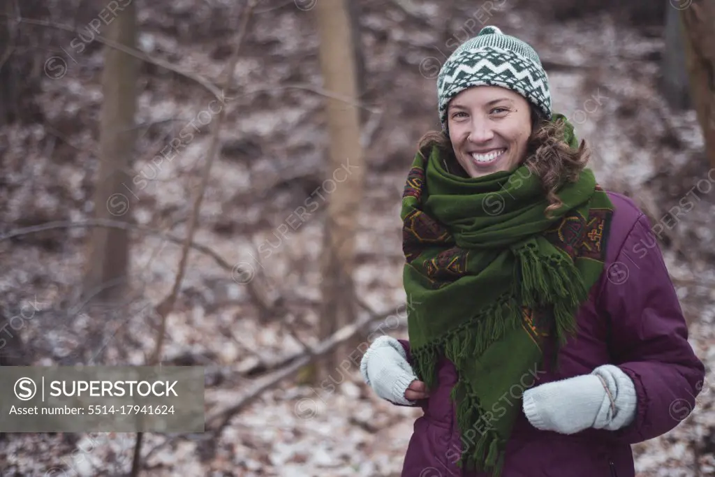 Happy healthy active woman outdoors on walk in winter in europe