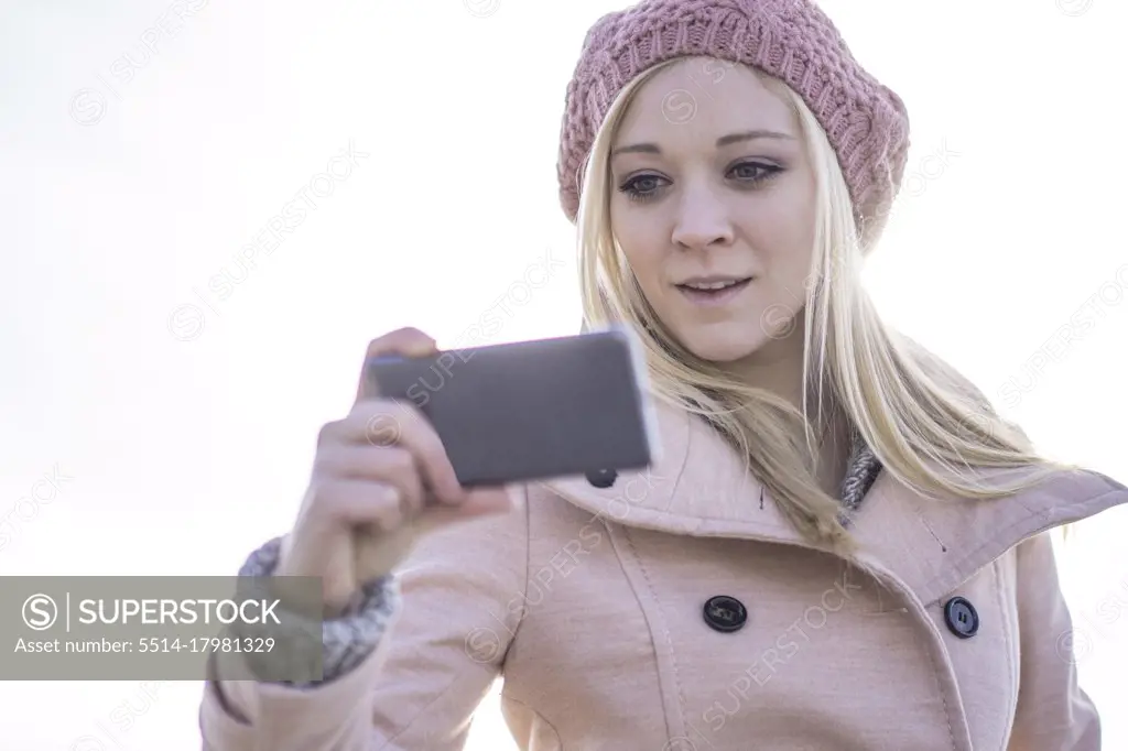 Female solo traveler using smartphone