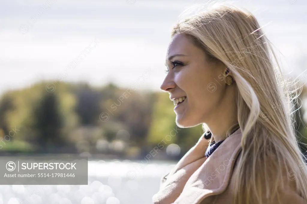 Portrait of blonde female fashion model in autumn clothing smili