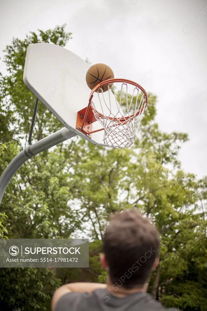 Man playing basketball doing a layup