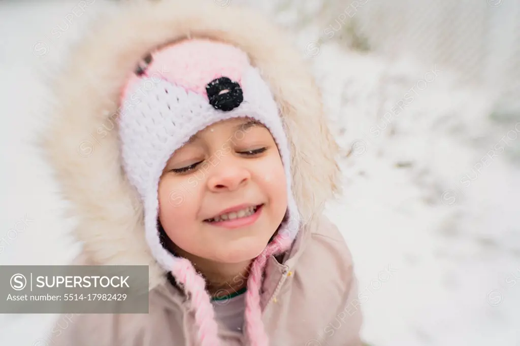 Young girl child happy in snow smiling
