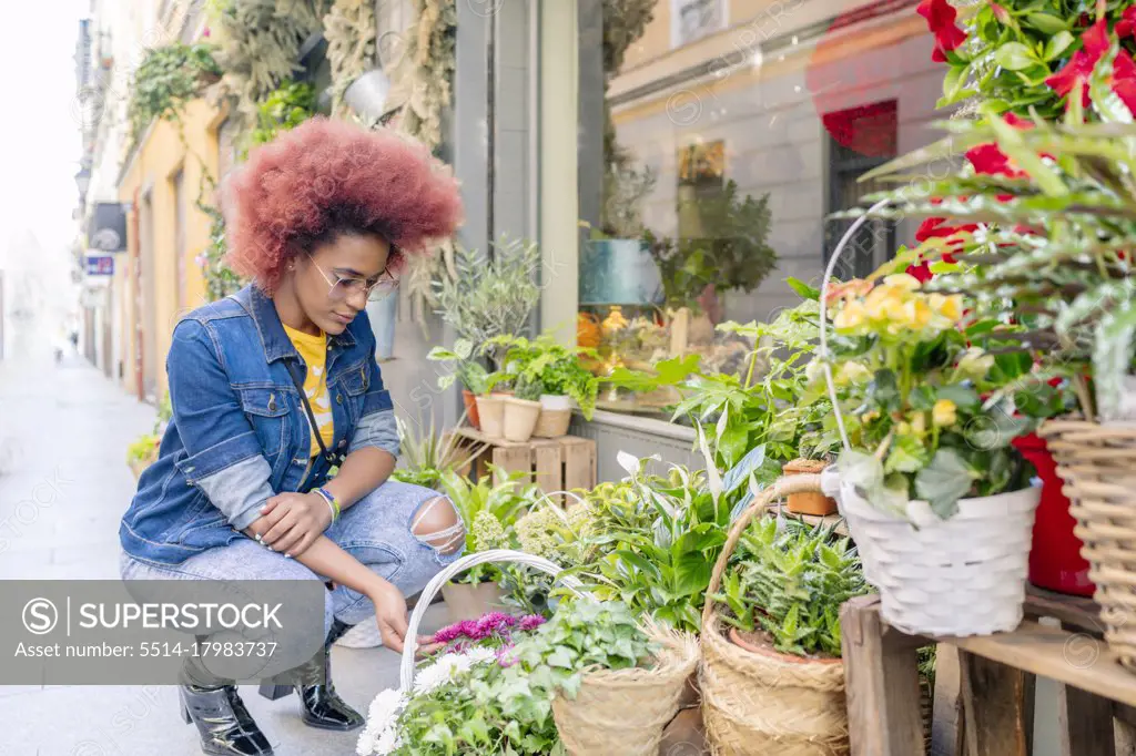woman with afro hair in a flower shop