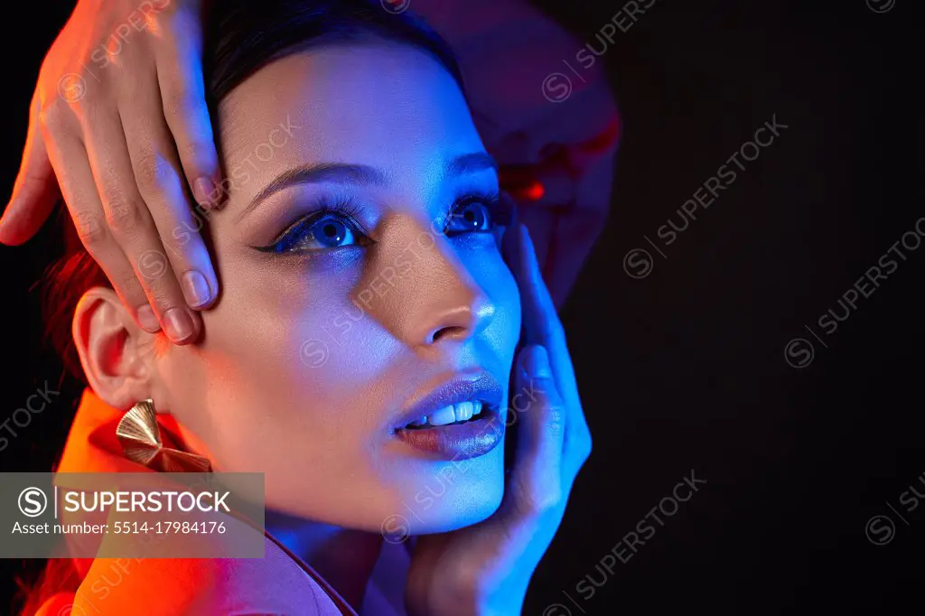 Close-up, face of young girl with bright makeup, neon photo filters
