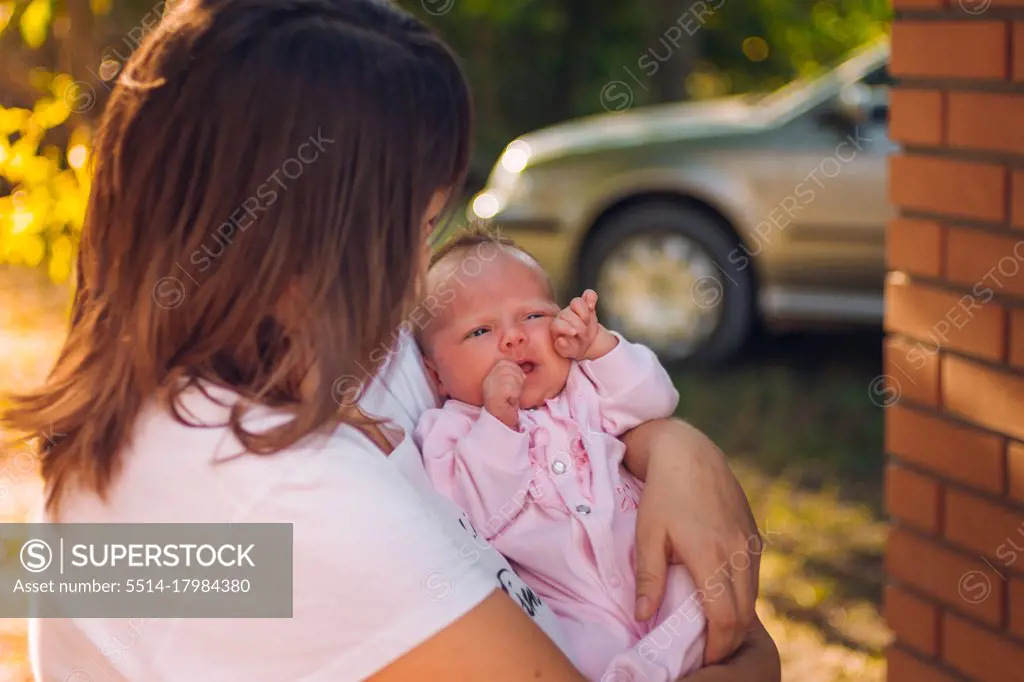 Photo of a mother holding her newborn baby daughter close
