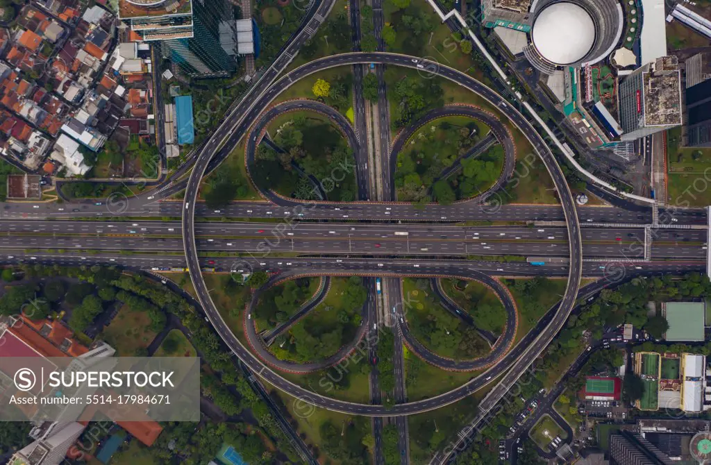 Top down overhead aerial view of large multi lane roundabout in Jakarta, Indonesia Large traffic junction on a highway with car traffic
