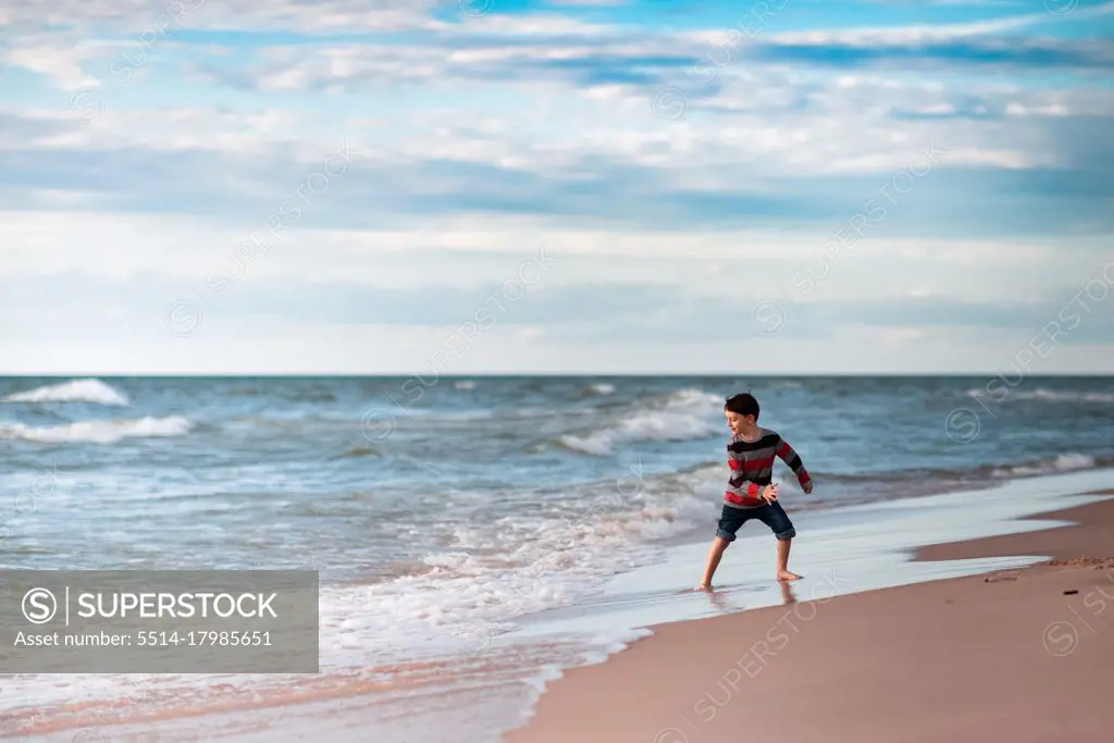 boy at Lake Michigan having fun in the water on the beach