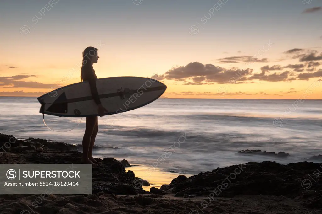 Surfer Girl Silhouette Against Colorful Sunset