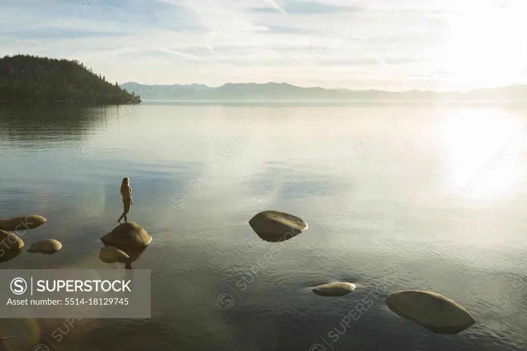 Female standing on rock in Lake Tahoe