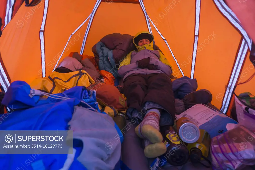 Female in tent smiling while winter camping