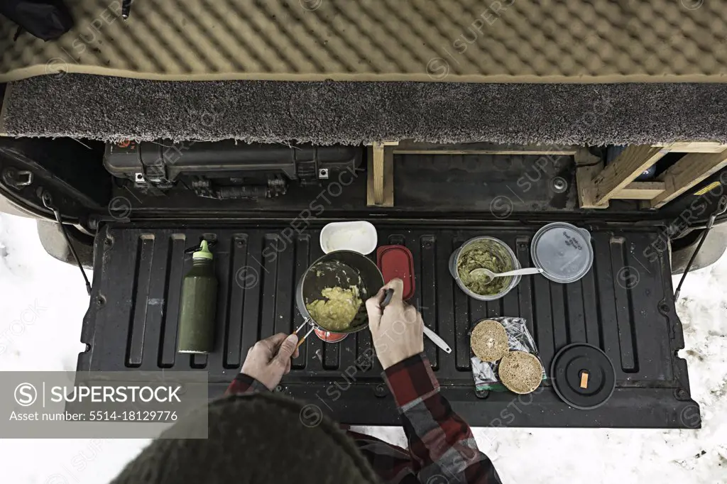 Cooking breakfast on tailgate of truck in winter