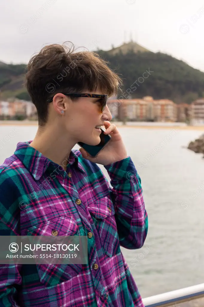 woman with short hair talking on the phone