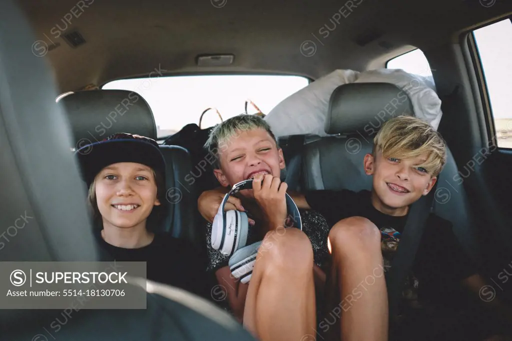 Three Best Friends on a Road Trip Giggle from the Backseat
