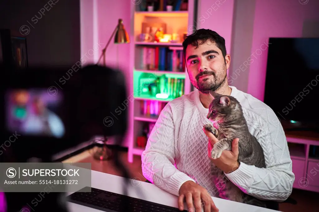 Young fat streamer on a room with multicolor lights