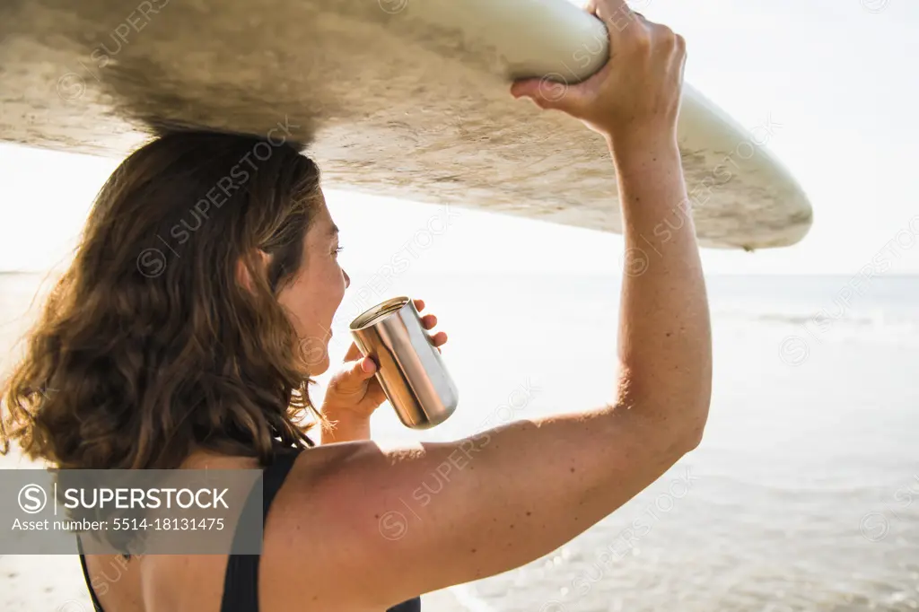 Woman Enjoying Morning Coffee before Surf