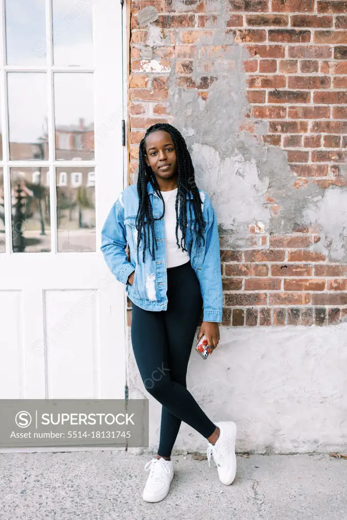 portrait headshot of beautiful young black woman in jean jacket
