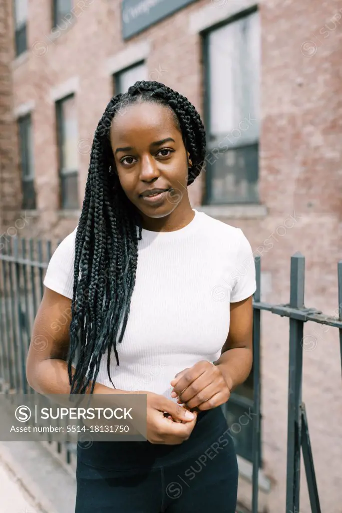 Close up portrait of a young black woman in a city area