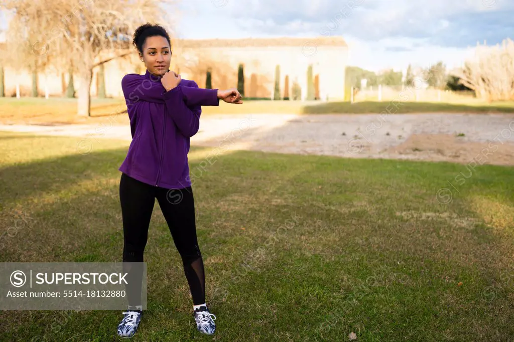 African American woman afro hair, stretching warming up before workout