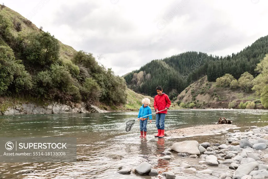 Brothers exploring beautful river in New Zealand