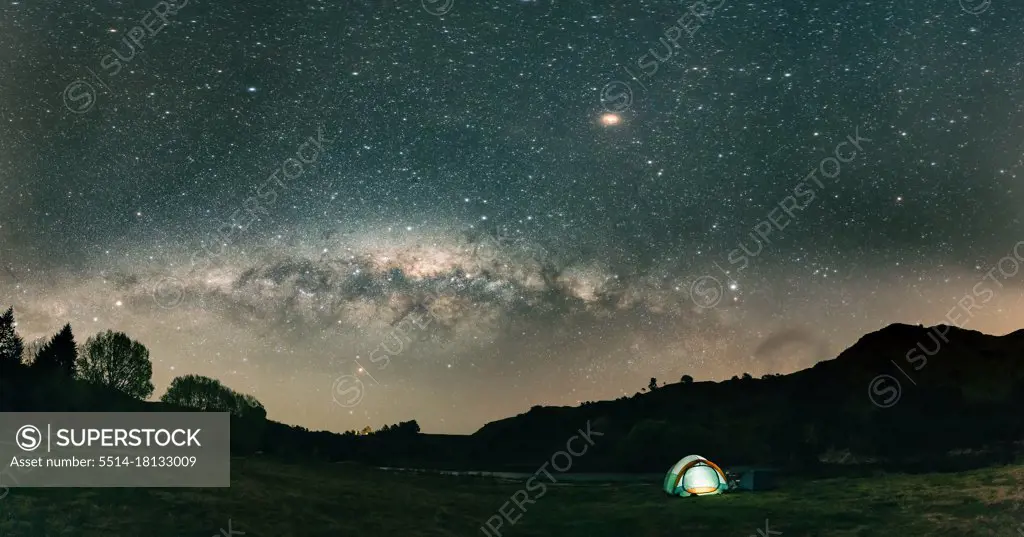 Panoramic view of beauriful night landscape with tent in New Zealand