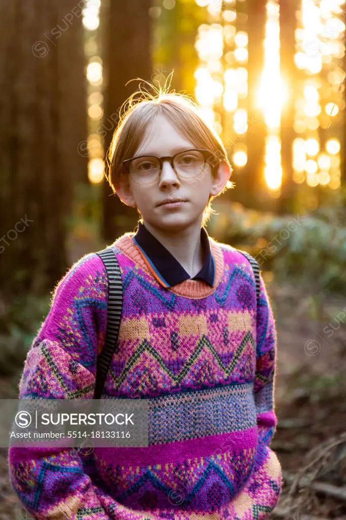 Portrait of calm young person looking at camera in redwood grove